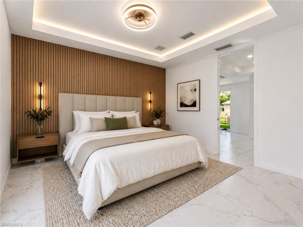 Virtually staged: Contemporary bedroom featuring a wood slat accent wall, recessed lighting, a modern ceiling fixture, and large format tile flooring