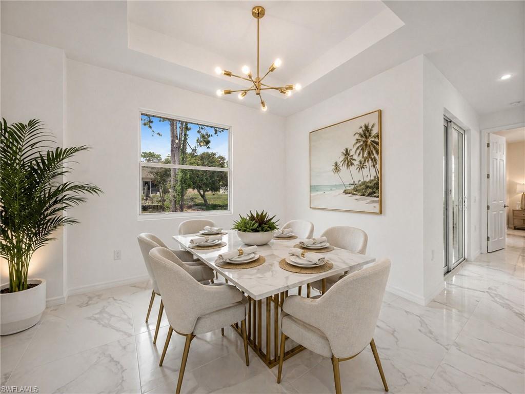 Virtually staged: Dining area with polished marble-look tile flooring
