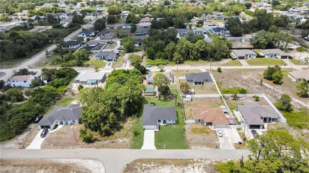 Aerial representation of a residential neighborhood featuring single-story homes, paved streets, and a mix of developed and undeveloped lots (grass color has been enhanced)