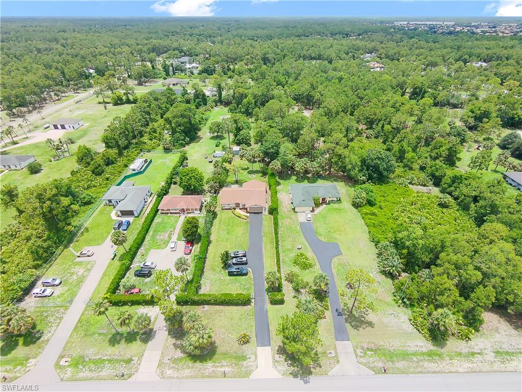 Expansive lot featuring mature trees and established landscaping
