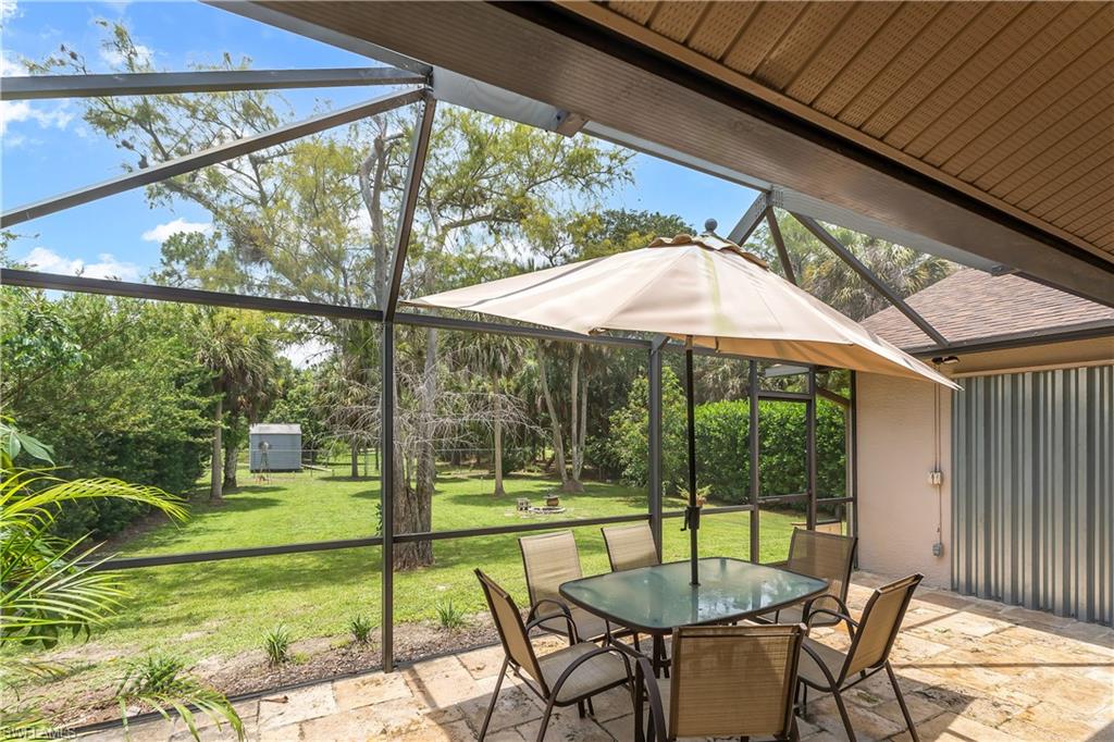 Screened patio with stone-finish flooring and a textured ceiling