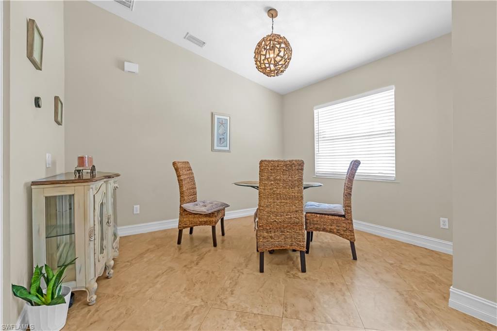Vaulted ceiling, recessed lighting, and a window with horizontal blinds