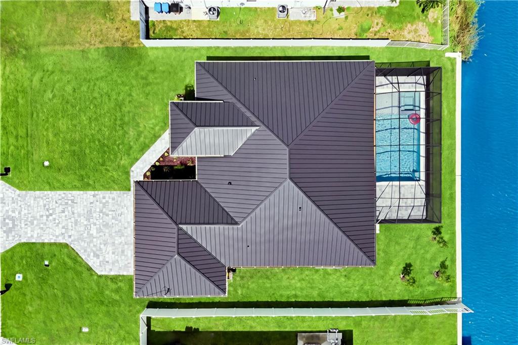 Located in SW Cape Coral, durable METAL ROOF & 3-CAR GARAGE!