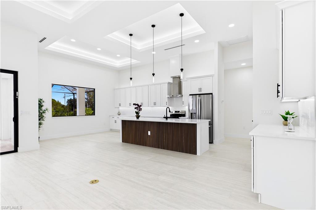 QUARTZ COUNTERTOPS & FULL-HEIGHT QUARTZ BACKSPLASH w/ clean modern palette, while UNDER-CABINET LED LIGHTING enhances bright, open ambiance.