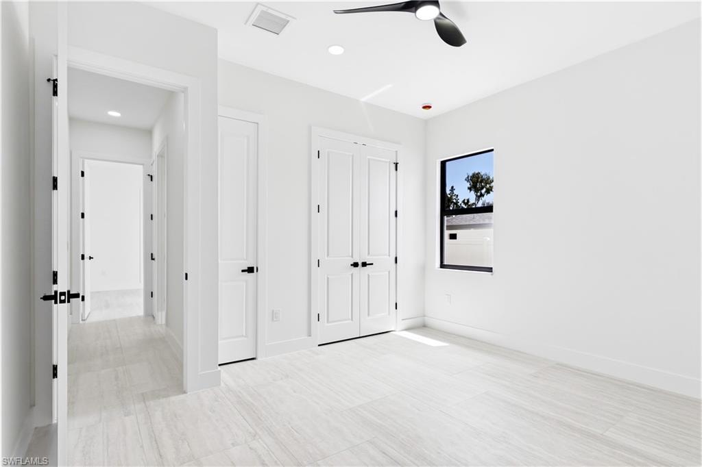 A COMFORTABLE THIRD BEDROOM offers a bright, peaceful retreat for FAMILY or GUESTS w/ modern finishes & generous closet space.