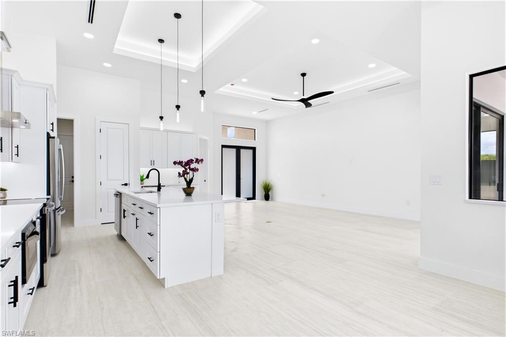 Living, dining, kitchen, and primary suite feature RECESSED CEILINGS accented by sleek LED TRACK lighting.