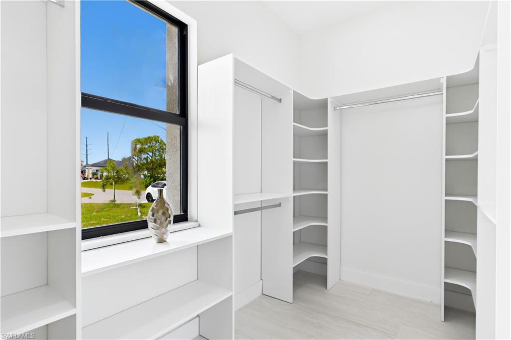 BUILT-IN CUSTOM CLOSET WHITE CABINETRY for ADDED STORAGE & CLEAN, UPSCALE LOOK.