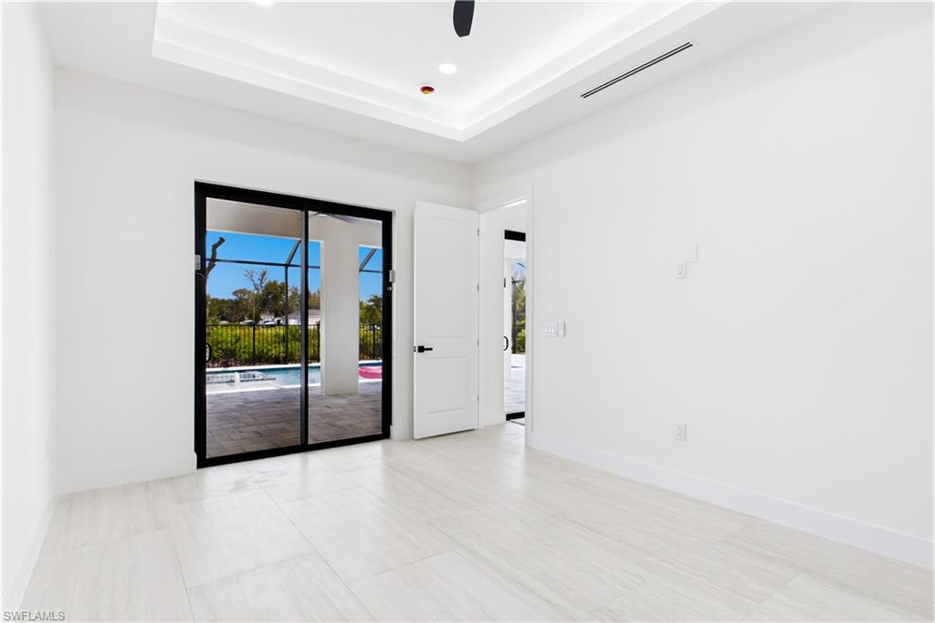 LARGE PRIMARY SUITE w/ sliding doors to lanai, WALK-IN CLOSET w/ BUILT-IN SHELVING & HANGING RACKS & LUXURIOUS PRIMARY BATHROOM
