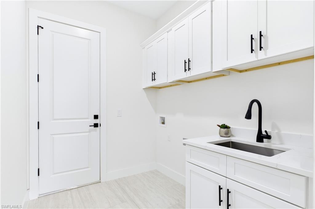 FUNCTIONAL LAUNDRY ROOM combines style & convenience w/ QUARTZ countertops, utility sink & abundant built-in cabinetry for effortless organization!