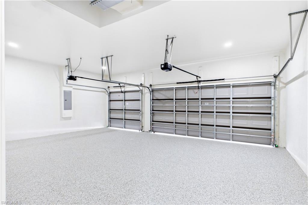 SPACIOUS 3-CAR GARAGE w/ durable EPOXY FLOORING offers plenty of room for vehicles, storage, bikes, water toys & all your SWFL LIFESTYLE essentials!