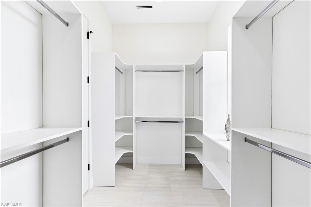 START & END YOUR DAY ORGANIZED w/ an expansive CUSTOM WALK-IN CLOSET offering abundant built-in shelving & hanging space for effortless everyday living!