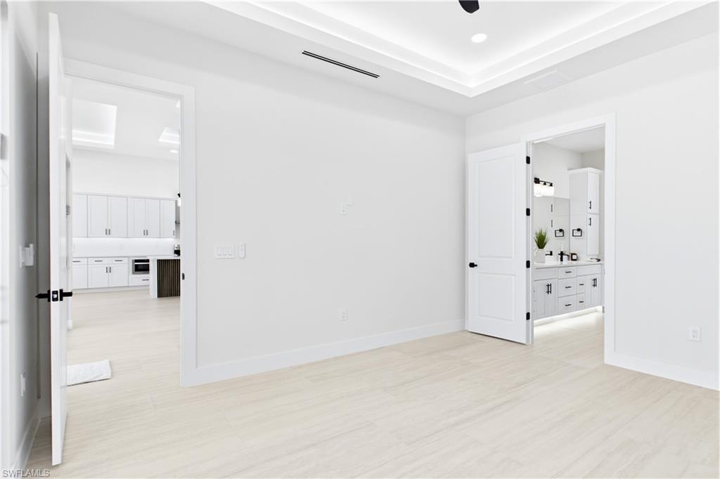 RETREAT to a SERENE PRIMARY SUITE designed for relaxation, w/ a spacious layout, ambient LED-LIT TRAY CEILING & spa-like ensuite.