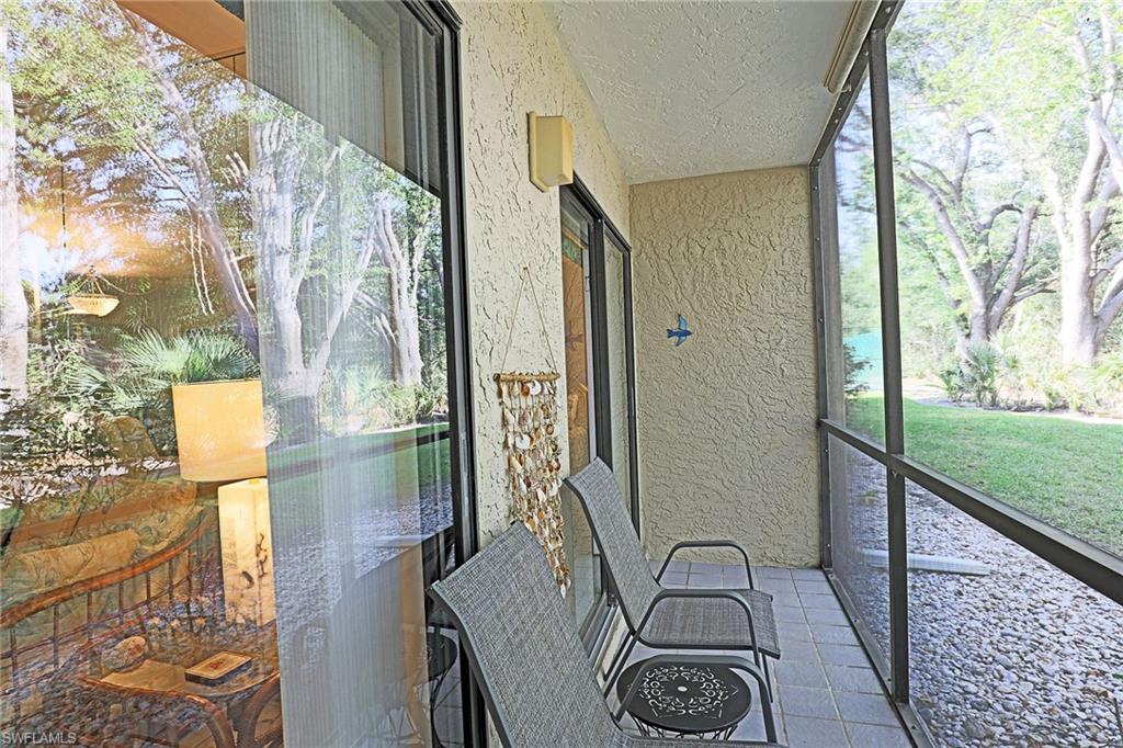 Screened porch with tile flooring and textured exterior wall
