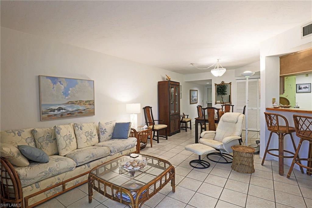 Tile flooring throughout, recessed lighting, and a breakfast bar