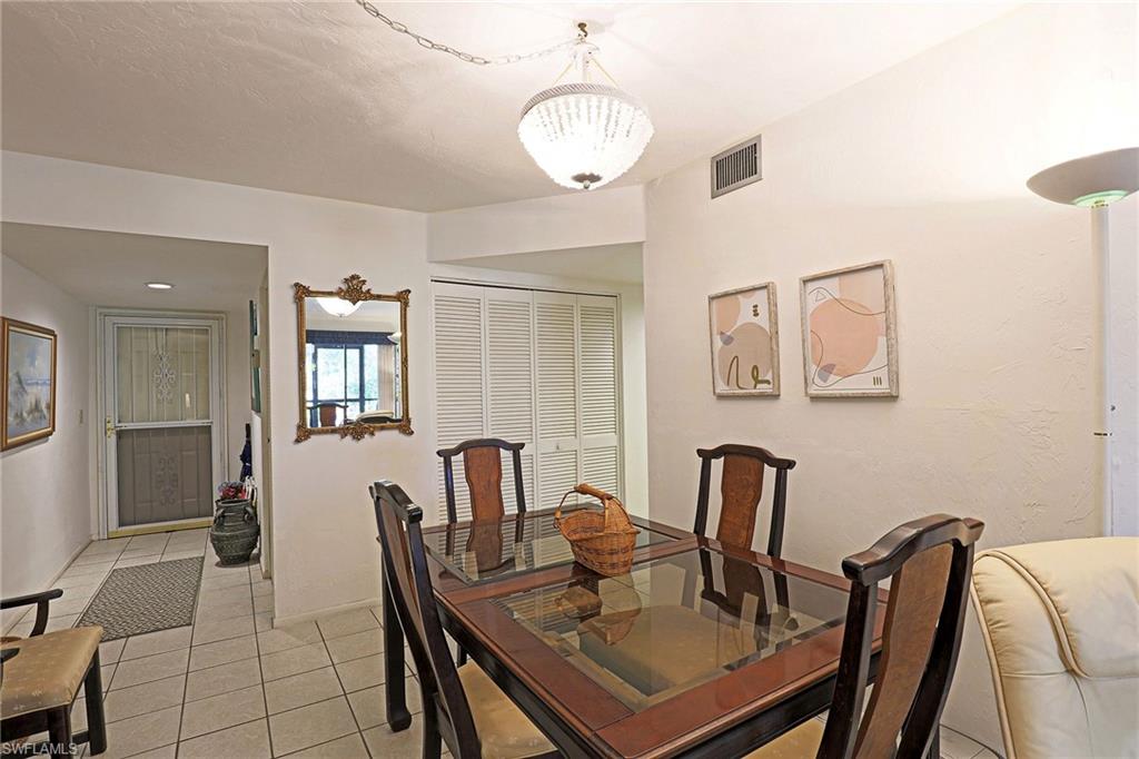 Tiled flooring, white walls, and a crystal chandelier