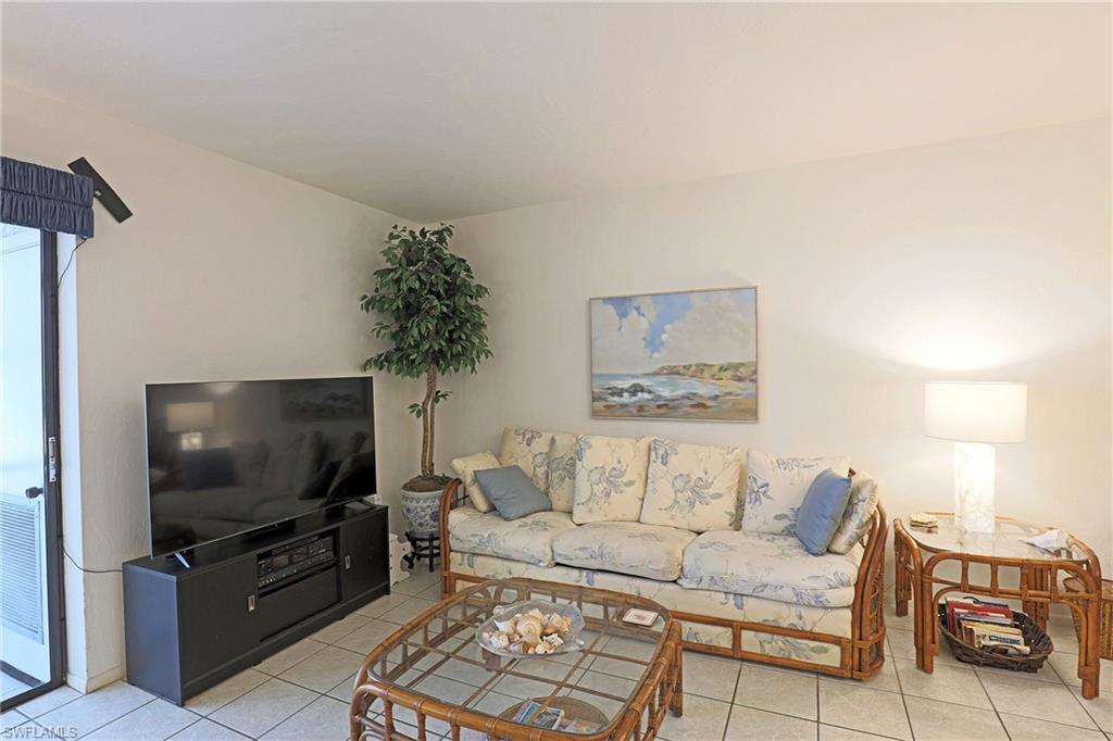 White tile flooring throughout, white walls, and a glass-paneled sliding door