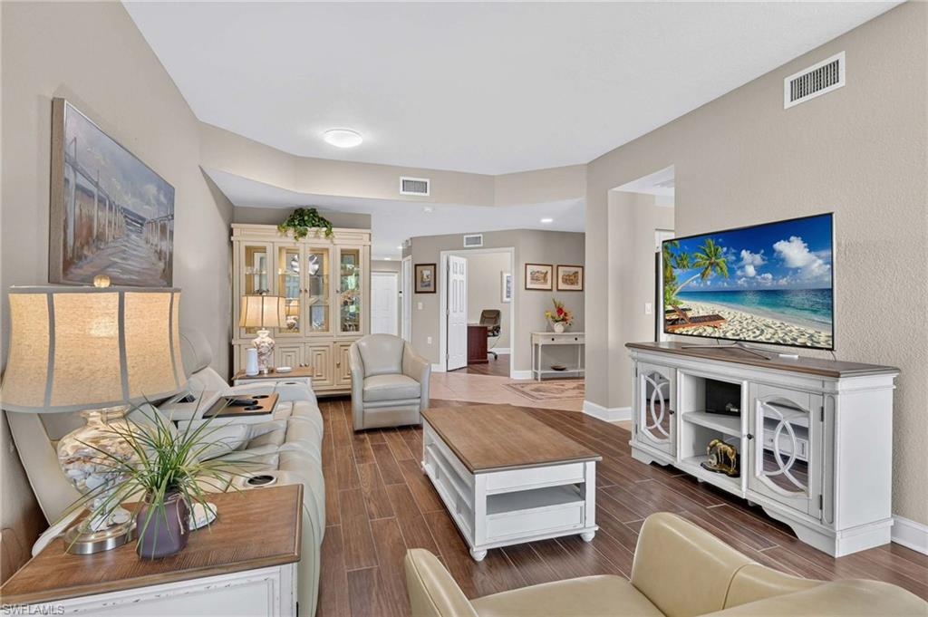 Wood-finish flooring throughout the main living area, complemented by light neutral wall tones and white trim