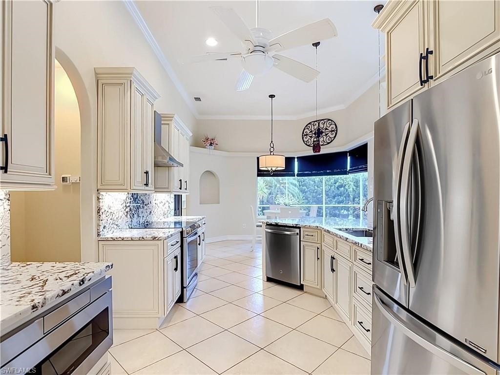Kitchen with stainless steel appliances, light-toned cabinetry, patterned tile backsplash, granite countertops, and white tile flooring