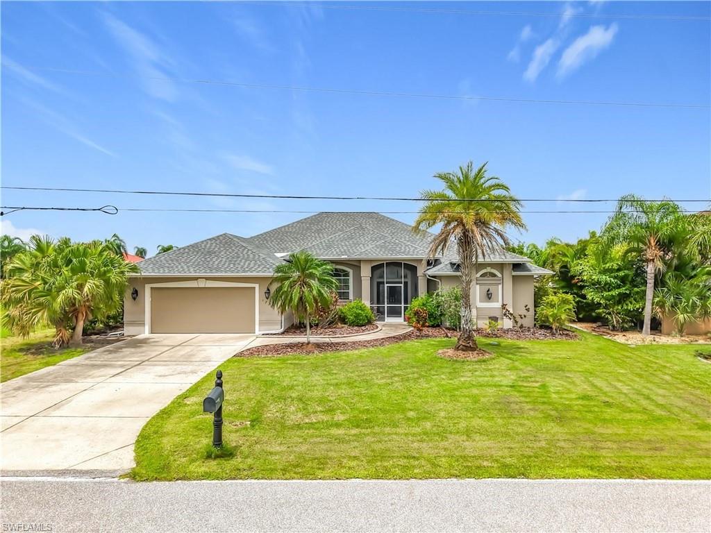 Stucco exterior with an attached garage and a screened entryway