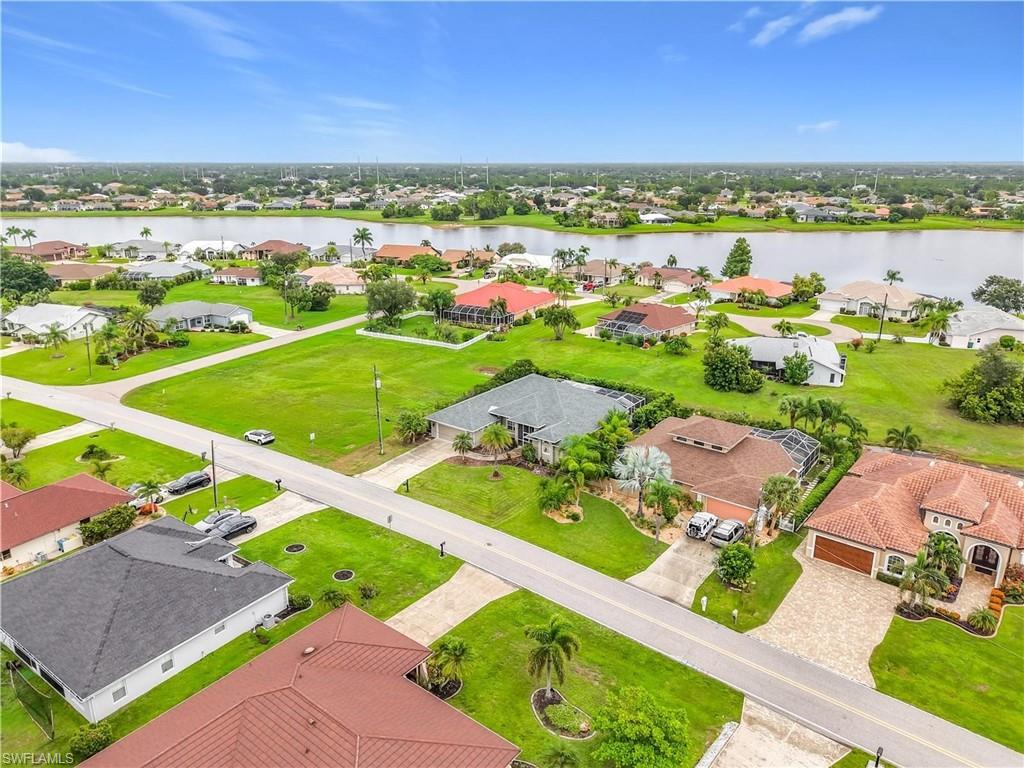 Expansive land parcel with direct water frontage, surrounded by established residences, and featuring a clear, level topography