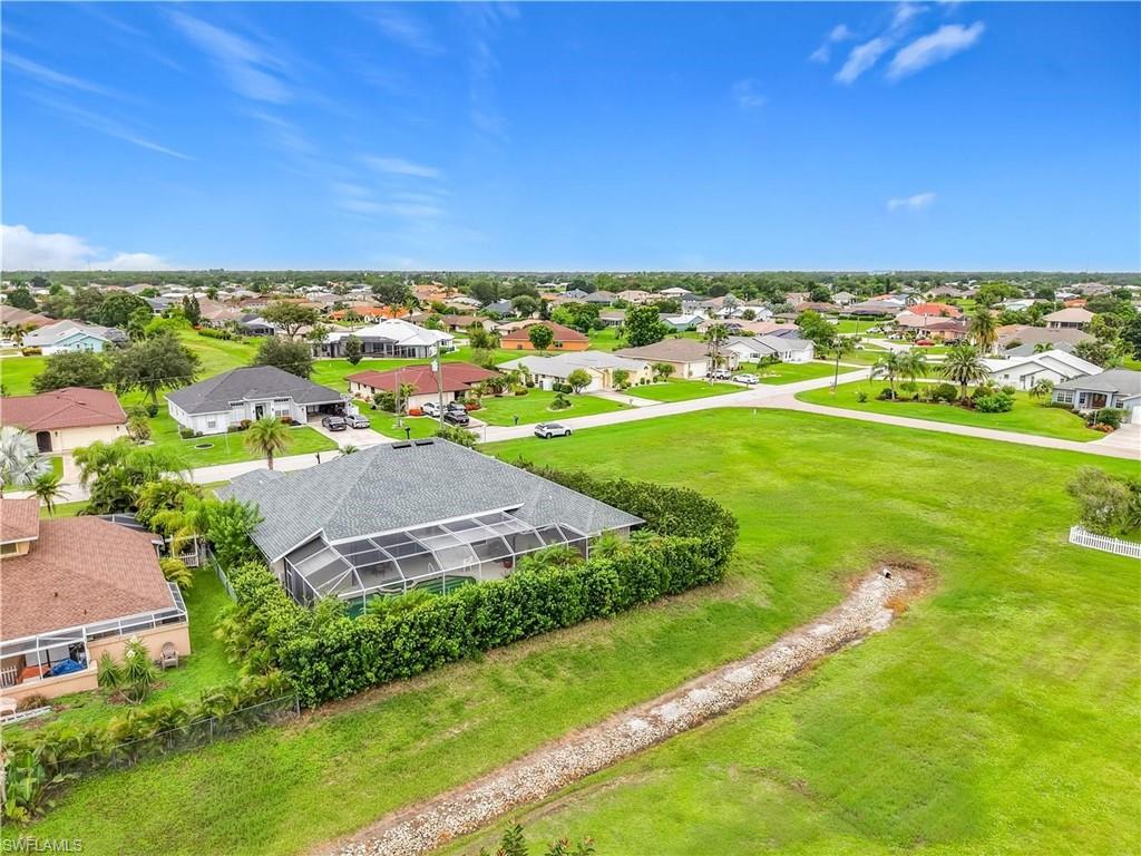 Property with expansive green space and a screened enclosure