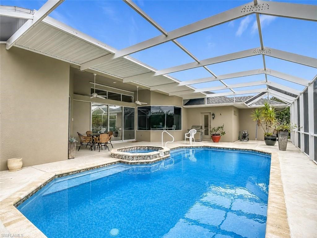 Screened enclosure with an in-ground swimming pool and integrated spa