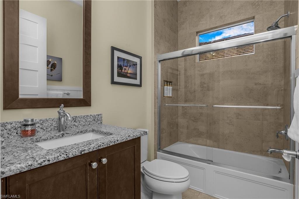 Vanity with speckled countertop, undermount sink, and chrome faucet