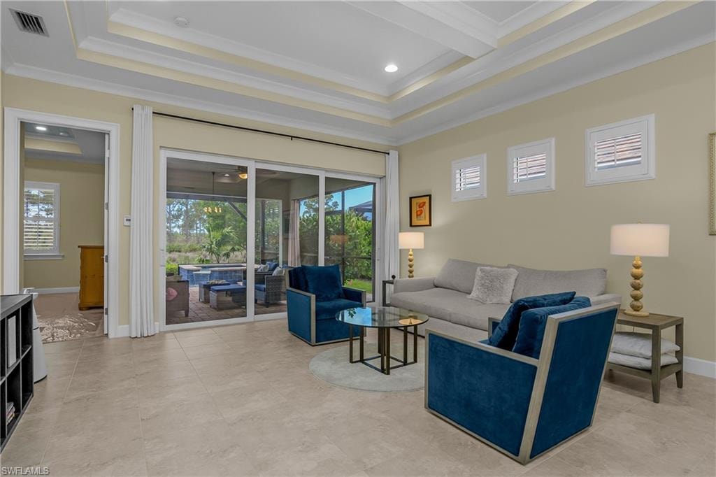 Recessed lighting within a tray ceiling, tiled flooring, plantation shutters, and sliding glass doors opening to an outdoor living area