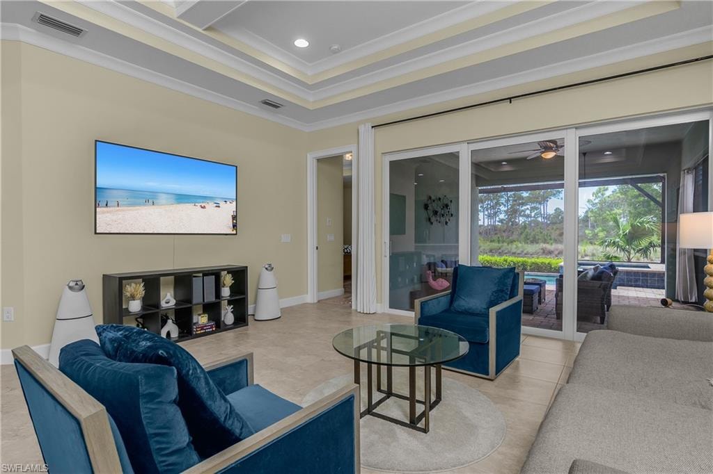 Tray ceiling with recessed lighting, large format tile flooring, and sliding glass doors