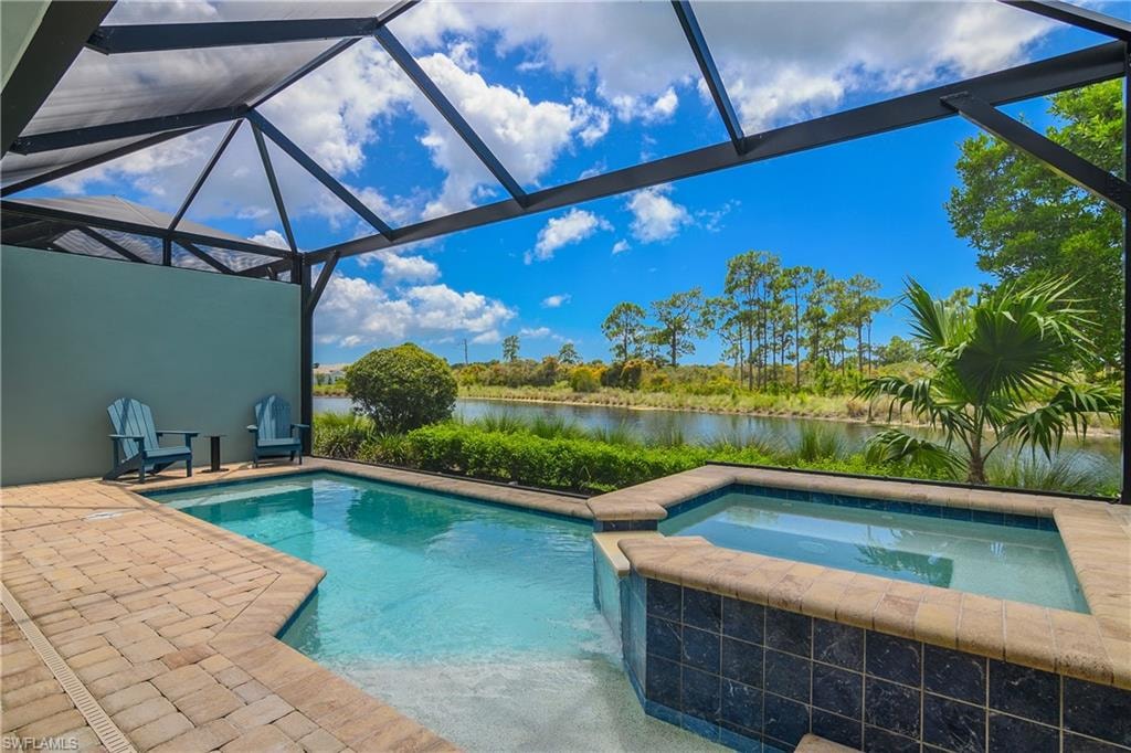 Screened lanai with a swimming pool and attached spa