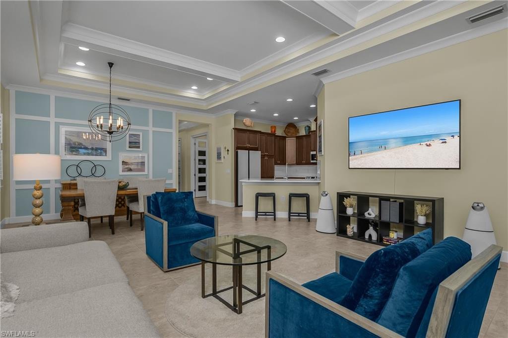 Tray ceiling with recessed lighting, tile flooring, built-in shelving, wall paneling, and an open concept layout