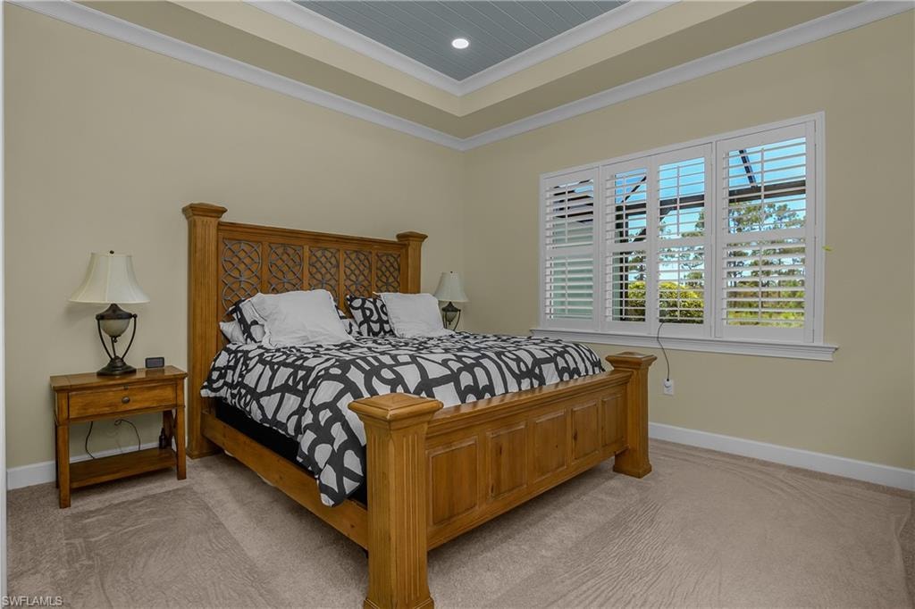 Tray ceiling with beadboard paneling, recessed lighting, crown molding, and plantation shutters