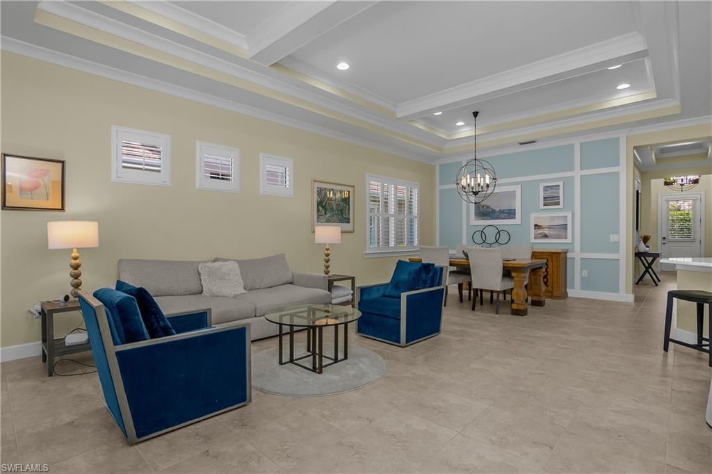 Open-concept living and dining areas featuring tray ceilings, crown molding, and recessed lighting