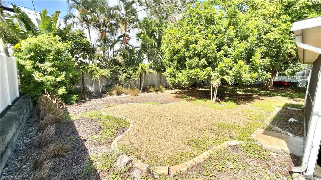 Expansive yard with mature trees, established plantings