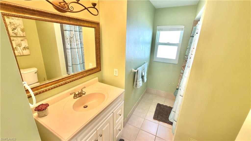 Vanity with integrated sink, framed mirror, and built-in cabinetry