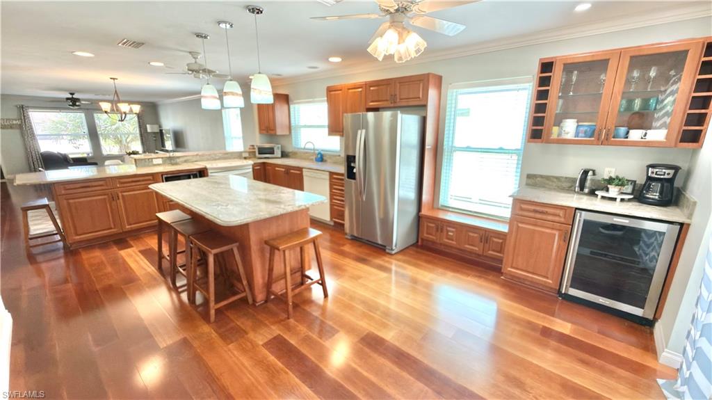 Gleaming wood-finish flooring throughout the open-concept kitchen.