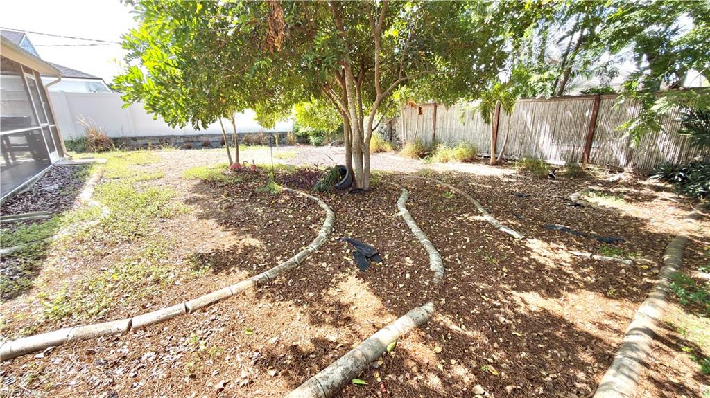 Expansive backyard featuring mature trees, wood-finish border elements