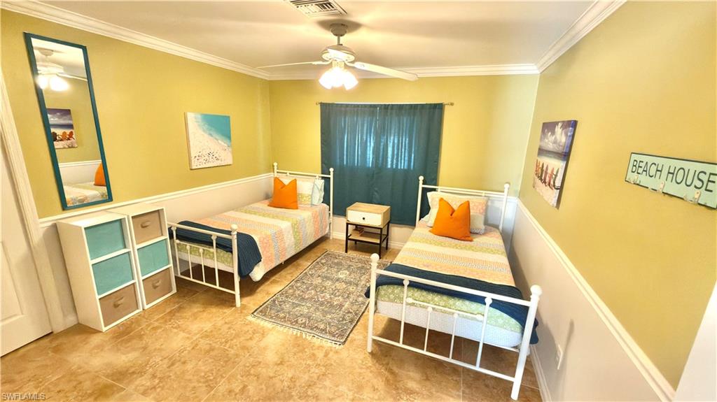 Recessed lighting, crown molding, and tile flooring