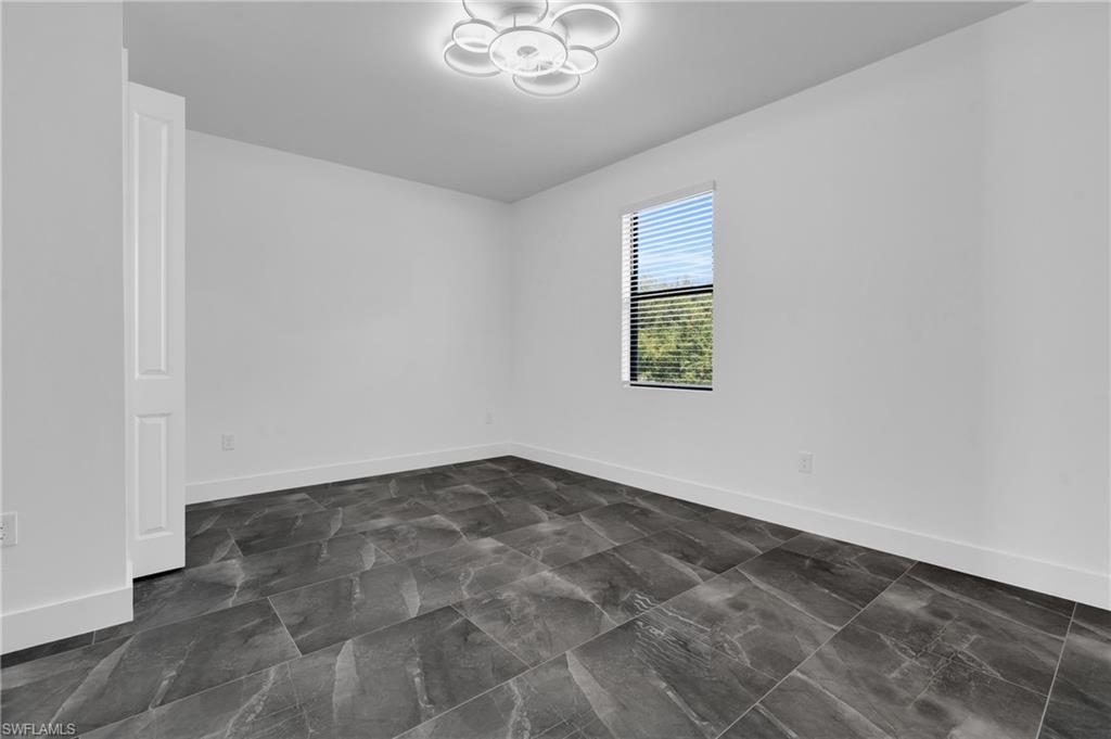 Spare room featuring baseboards