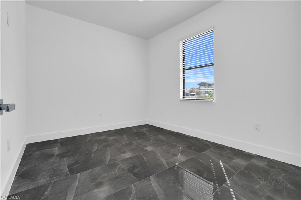 Spare room featuring baseboards