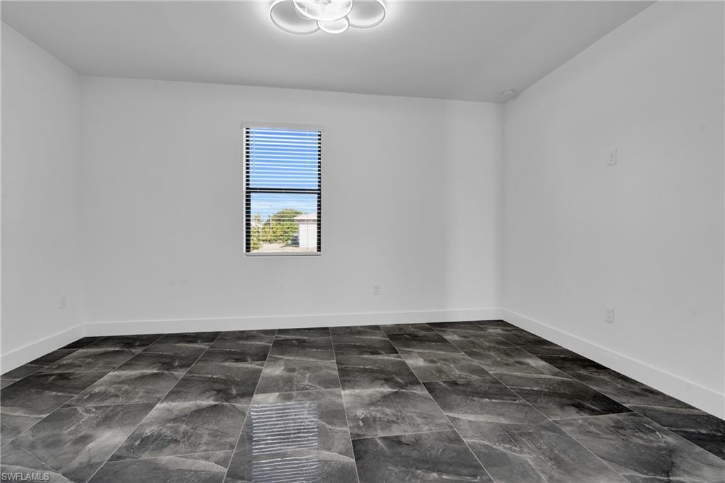 Empty room featuring baseboards