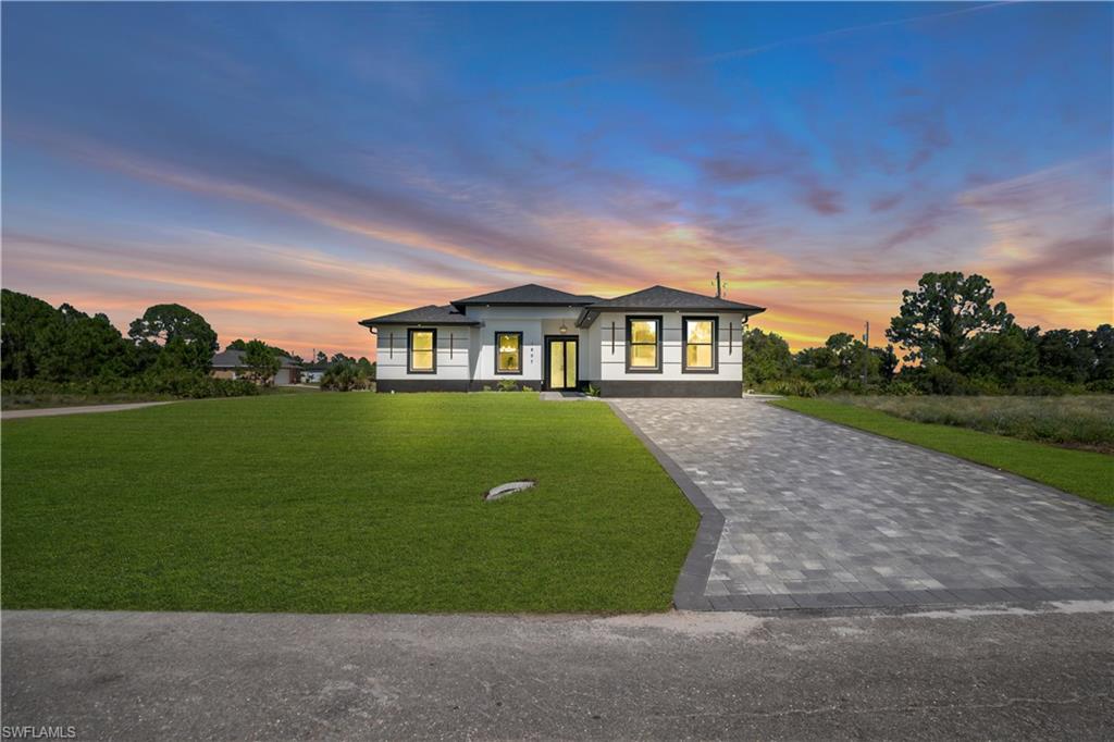 Contemporary exterior with white siding and dark trim