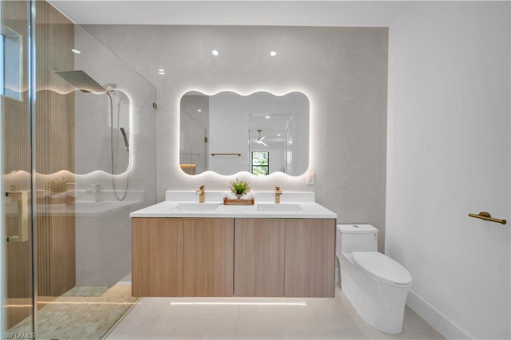 Dual vanity with wood-finish cabinetry and undermount sinks