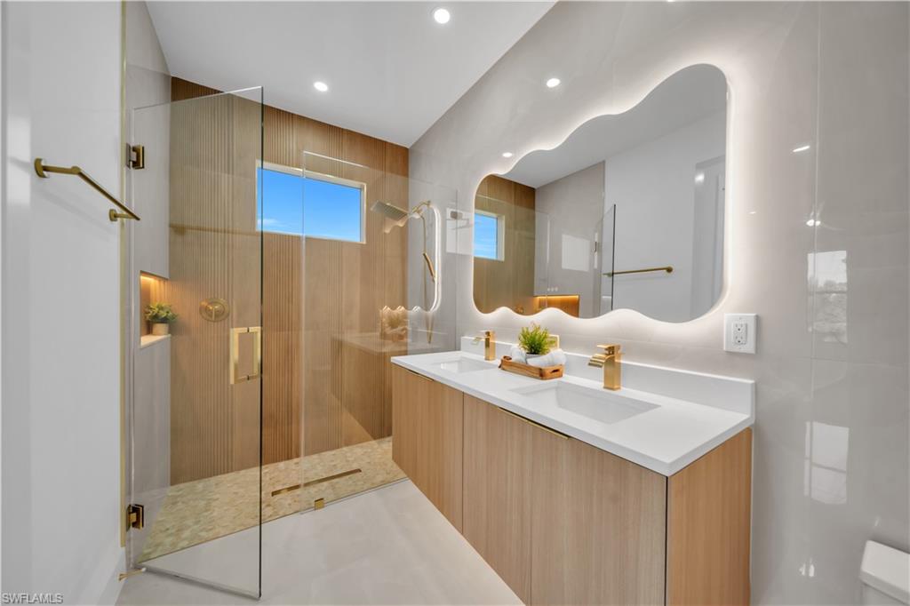 Dual vanity with integrated sinks and gold-finish fixtures