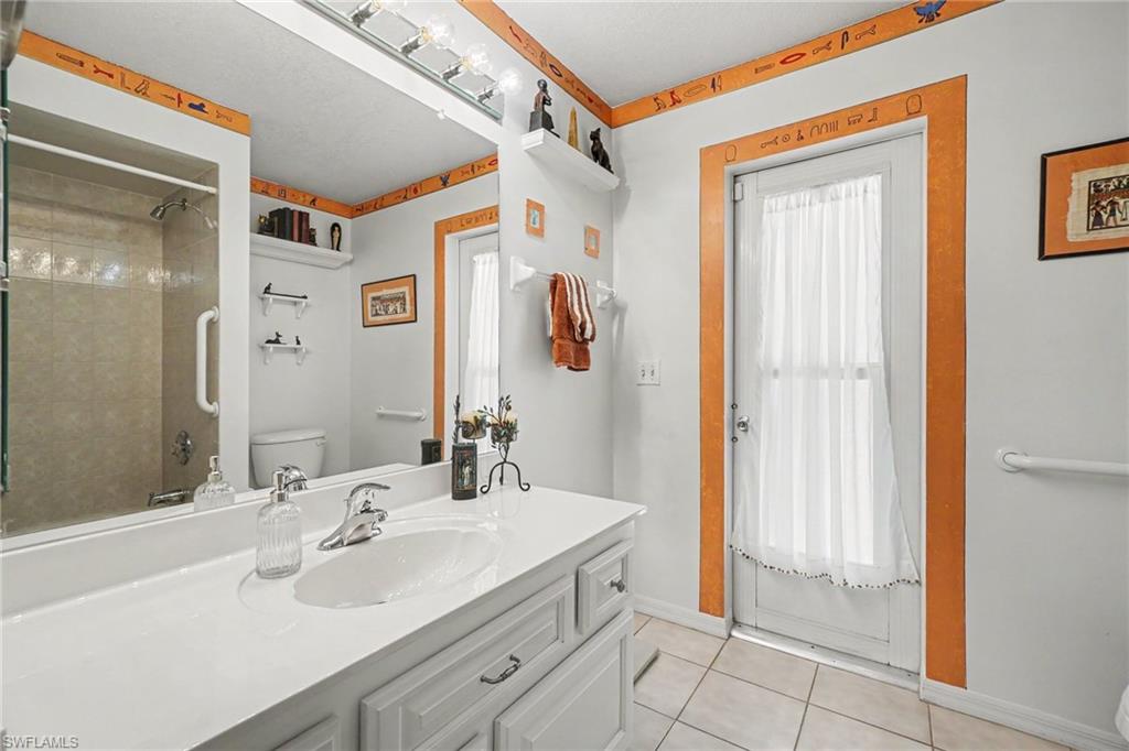 Vanity with integrated sink, chrome faucet, and storage cabinetry