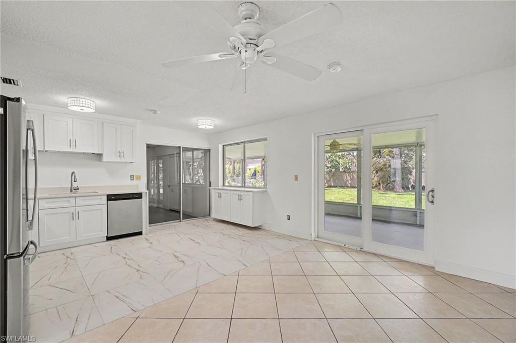 White cabinetry with stainless steel appliances and a single basin sink