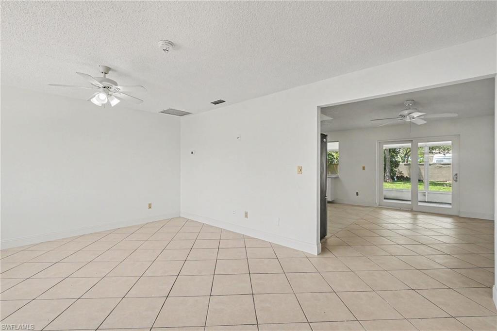 Tile flooring throughout, with a ceiling fan in each space