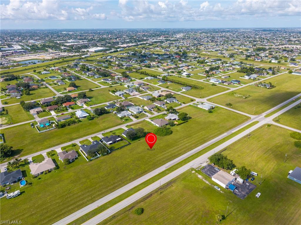 Aerial view of property's location featuring nearby suburban area