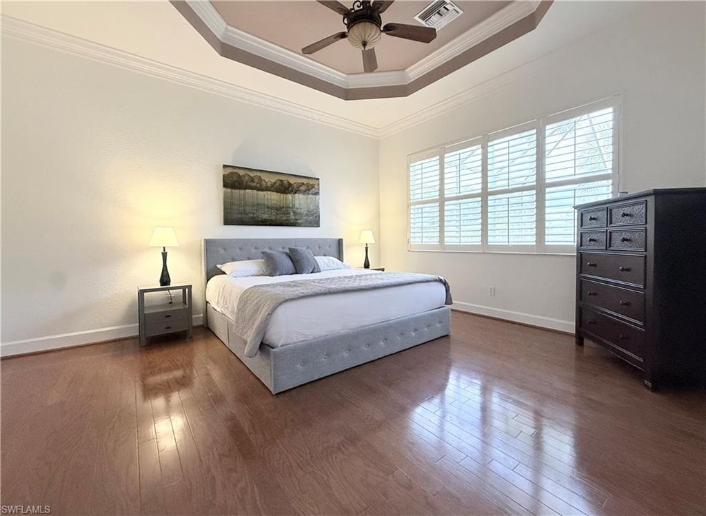 Spacious primary bedroom w/ laminate plank floors