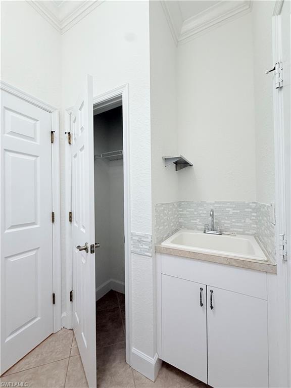Laundry has storage closet, cabinet & utility sink